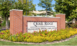 A sign for Quail Ridge Alzheimer's Special Care Center. Description generated by AI
